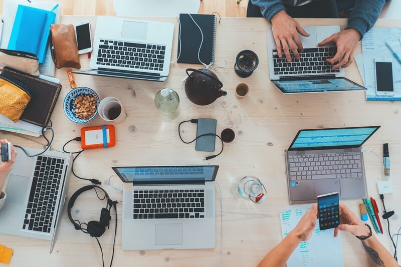 People working with equipment on desk